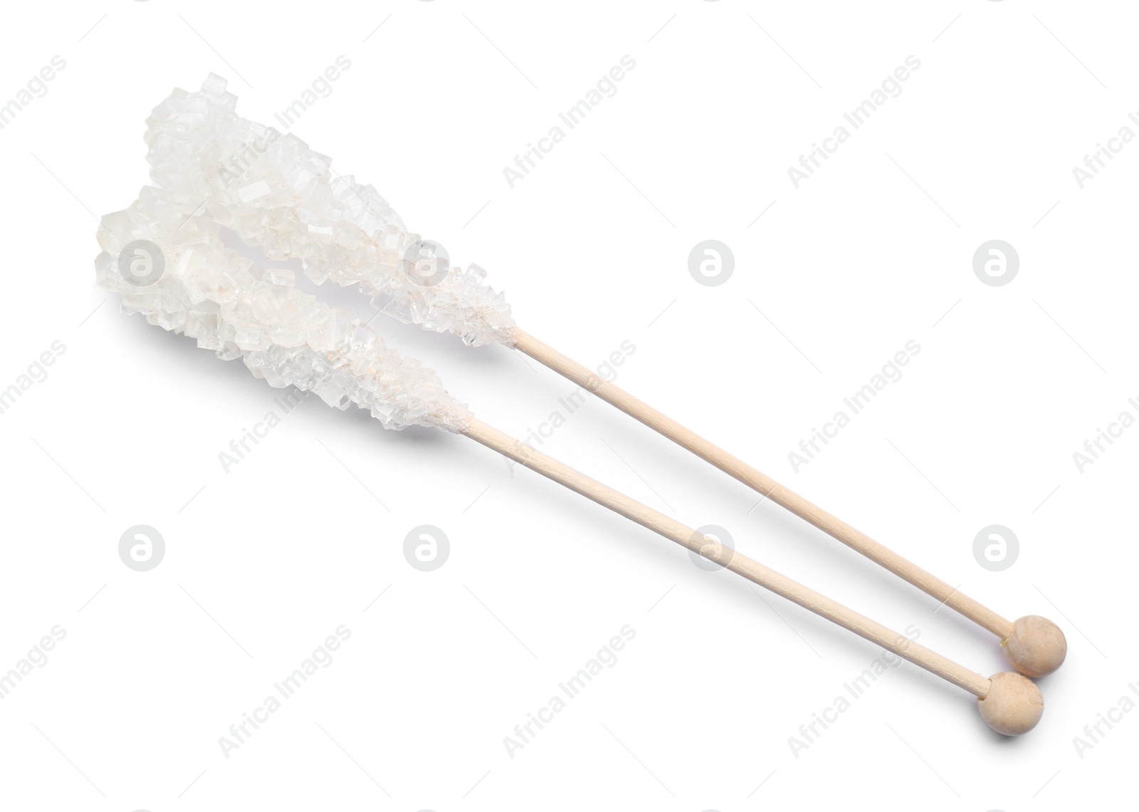 Photo of Wooden sticks with sugar crystals isolated on white, top view. Tasty rock candies