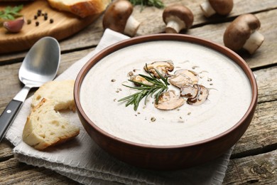 Fresh homemade mushroom soup served on wooden table, closeup