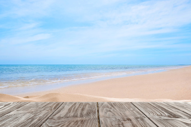 Image of Wooden surface on sandy beach near ocean