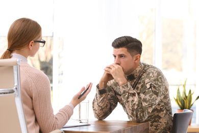 Psychotherapist working with military officer in office