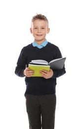 Photo of Portrait of cute boy in school uniform with books on white background