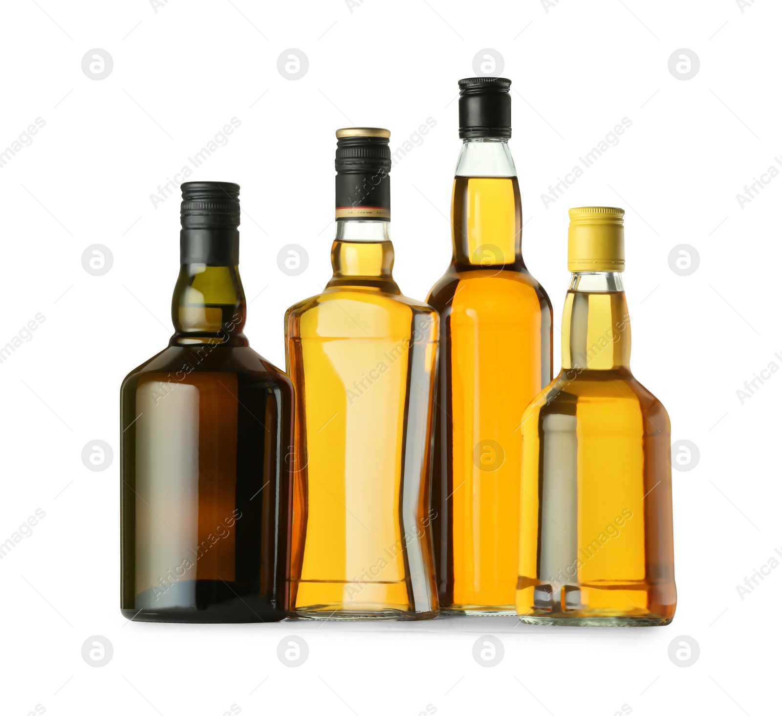 Photo of Different sorts of whiskey in glass bottles isolated on white