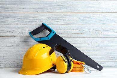 Photo of Composition with construction tools on table against wooden background, space for text