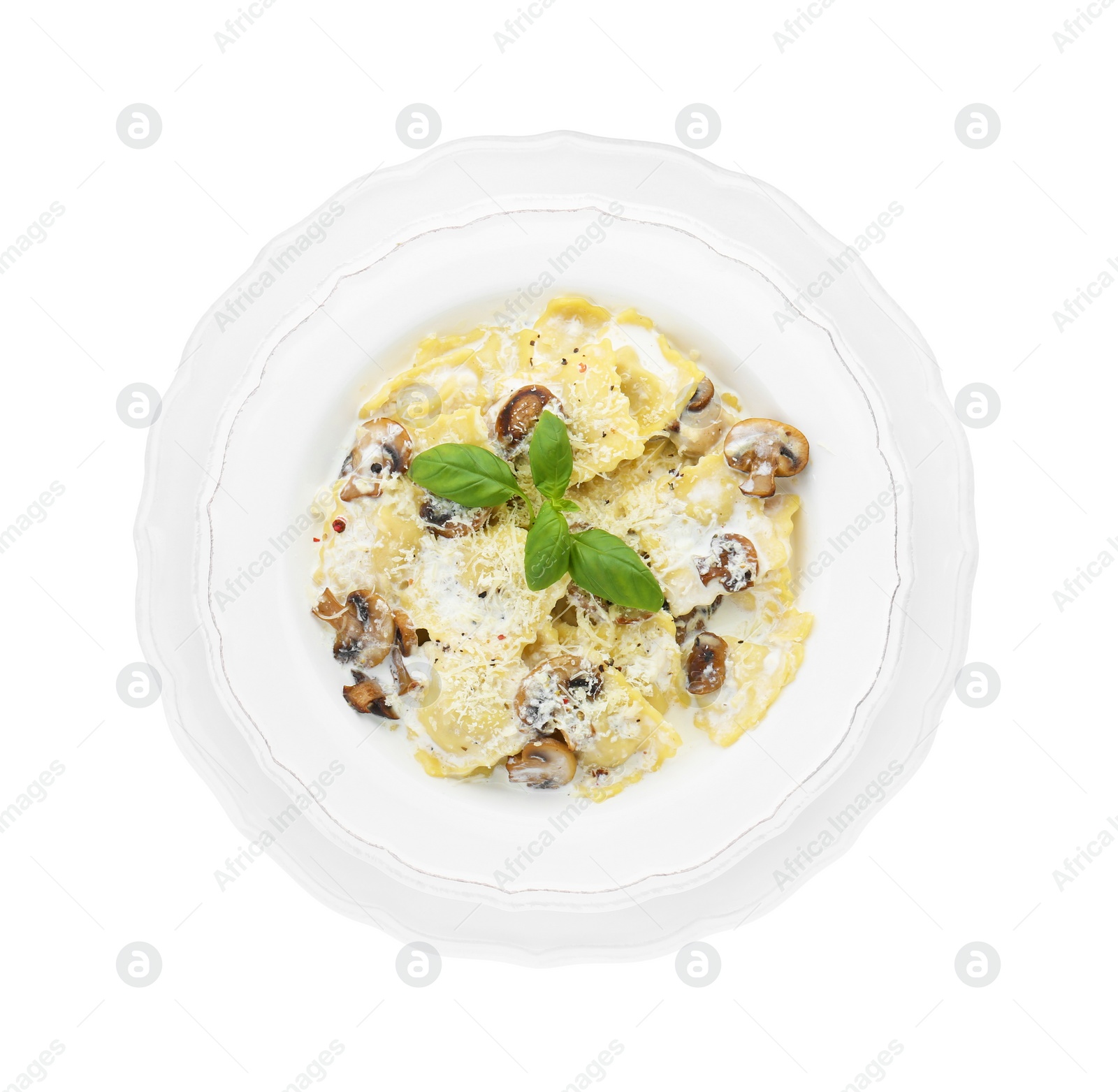 Photo of Delicious ravioli with tasty sauce and mushrooms isolated on white, top view