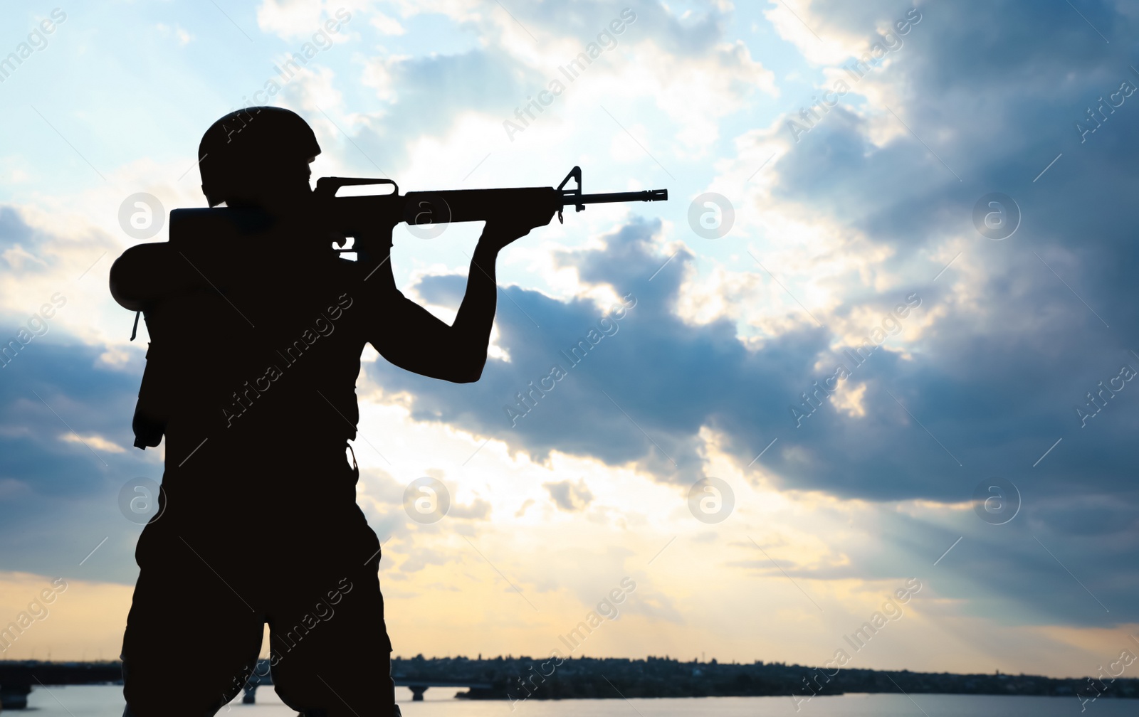 Photo of Soldier with machine gun patrolling outdoors. Military service