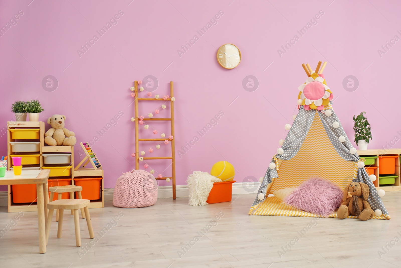 Photo of Modern nursery room interior with play tent for kids