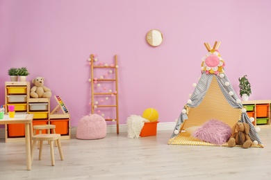 Modern nursery room interior with play tent for kids