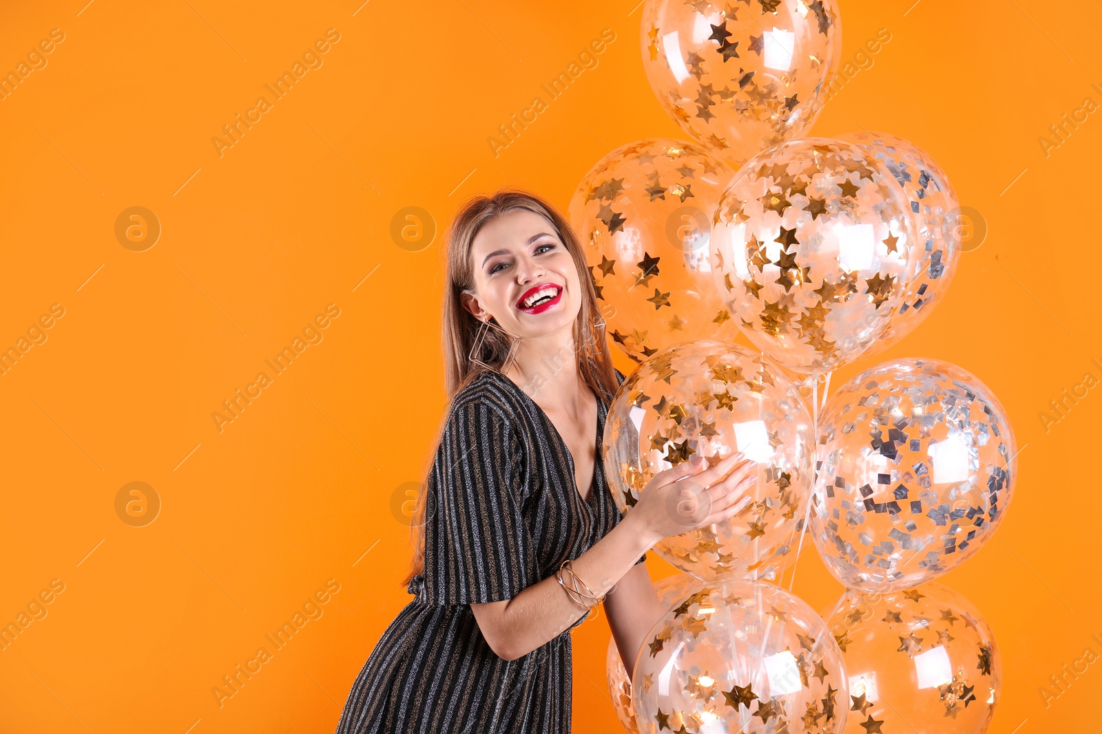 Photo of Young woman with air balloons and space for text on color background