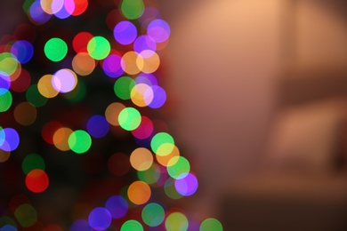 Photo of Blurred view of room interior with decorated Christmas tree