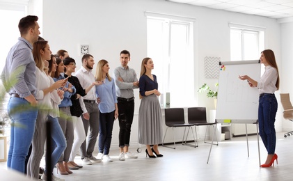 Photo of Female business trainer giving lecture in office