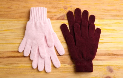 Stylish gloves on wooden background, flat lay