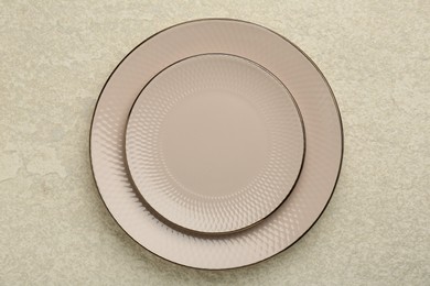 Photo of Beautiful ceramic plates on beige table, top view