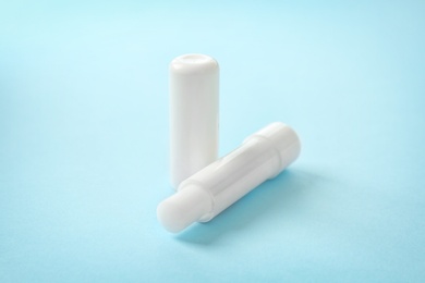 Photo of Hygienic lipstick on color background