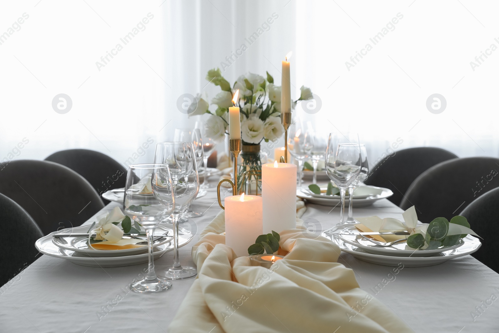 Photo of Festive table setting with beautiful floral decor in restaurant