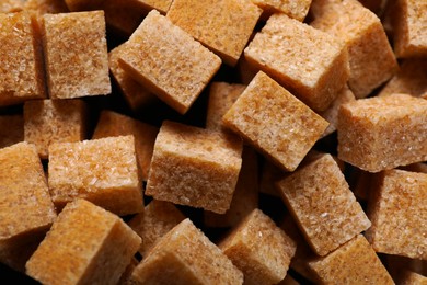 Photo of Brown sugar cubes as background, top view