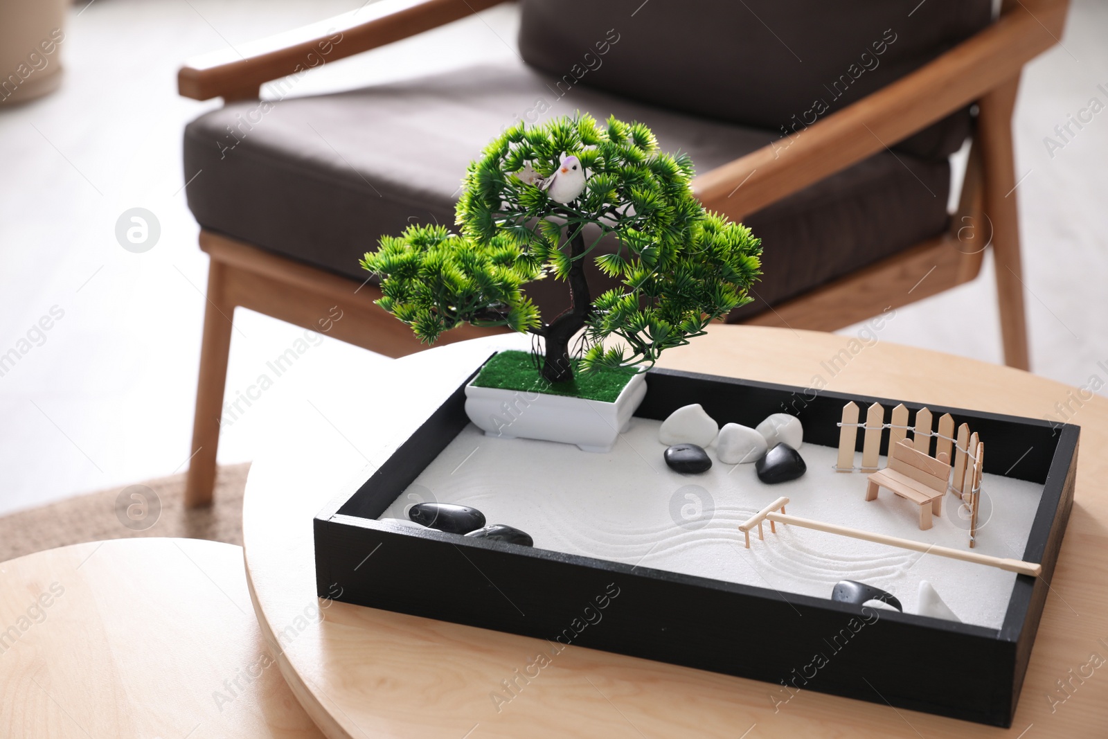 Photo of Beautiful miniature zen garden on wooden table indoors