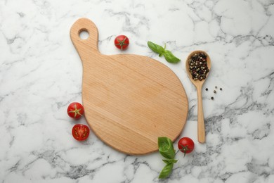 Photo of Cutting board, basil, spices and tomatoes on white marble table, flat lay. Space for text