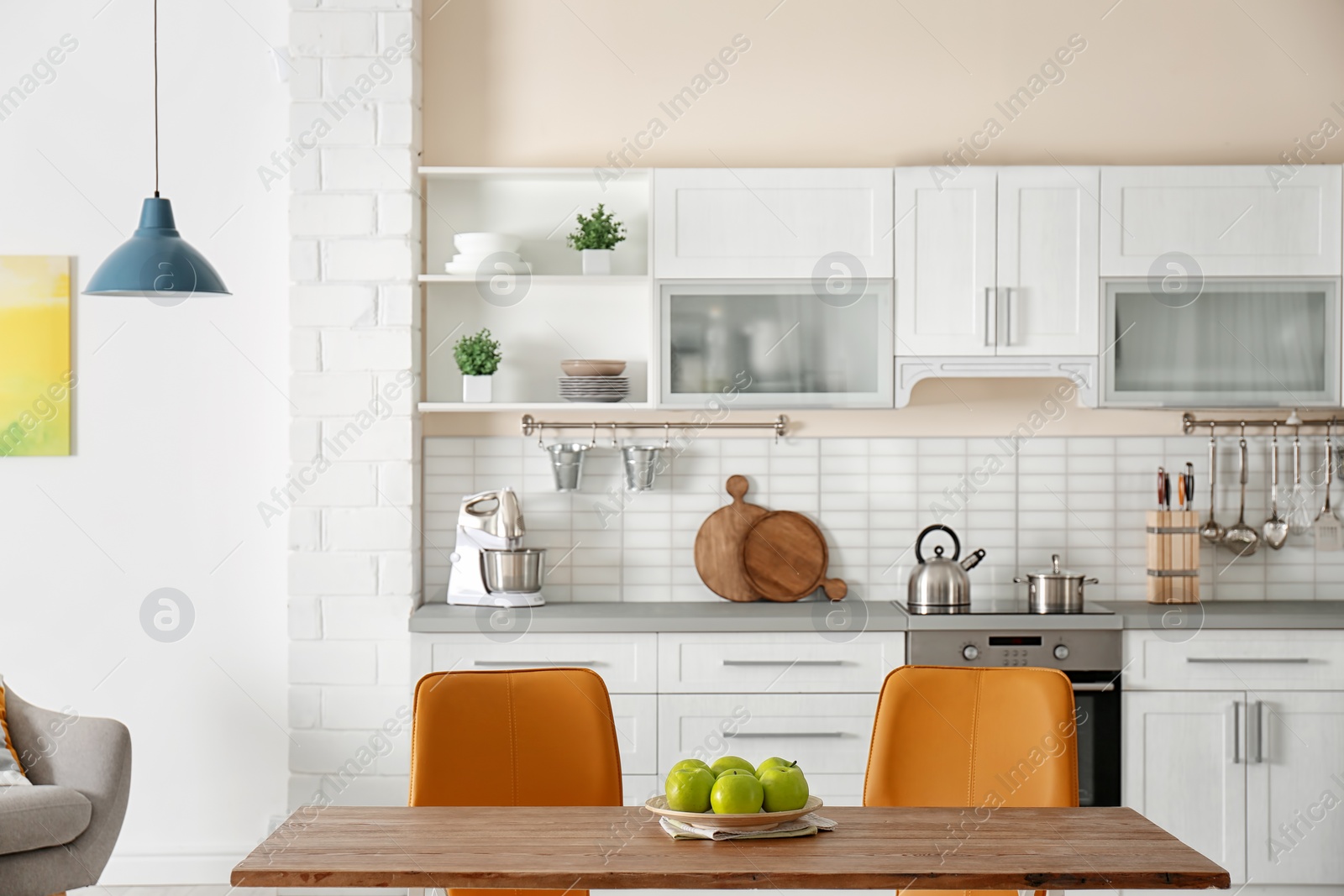 Photo of Stylish kitchen interior with dining table and chairs