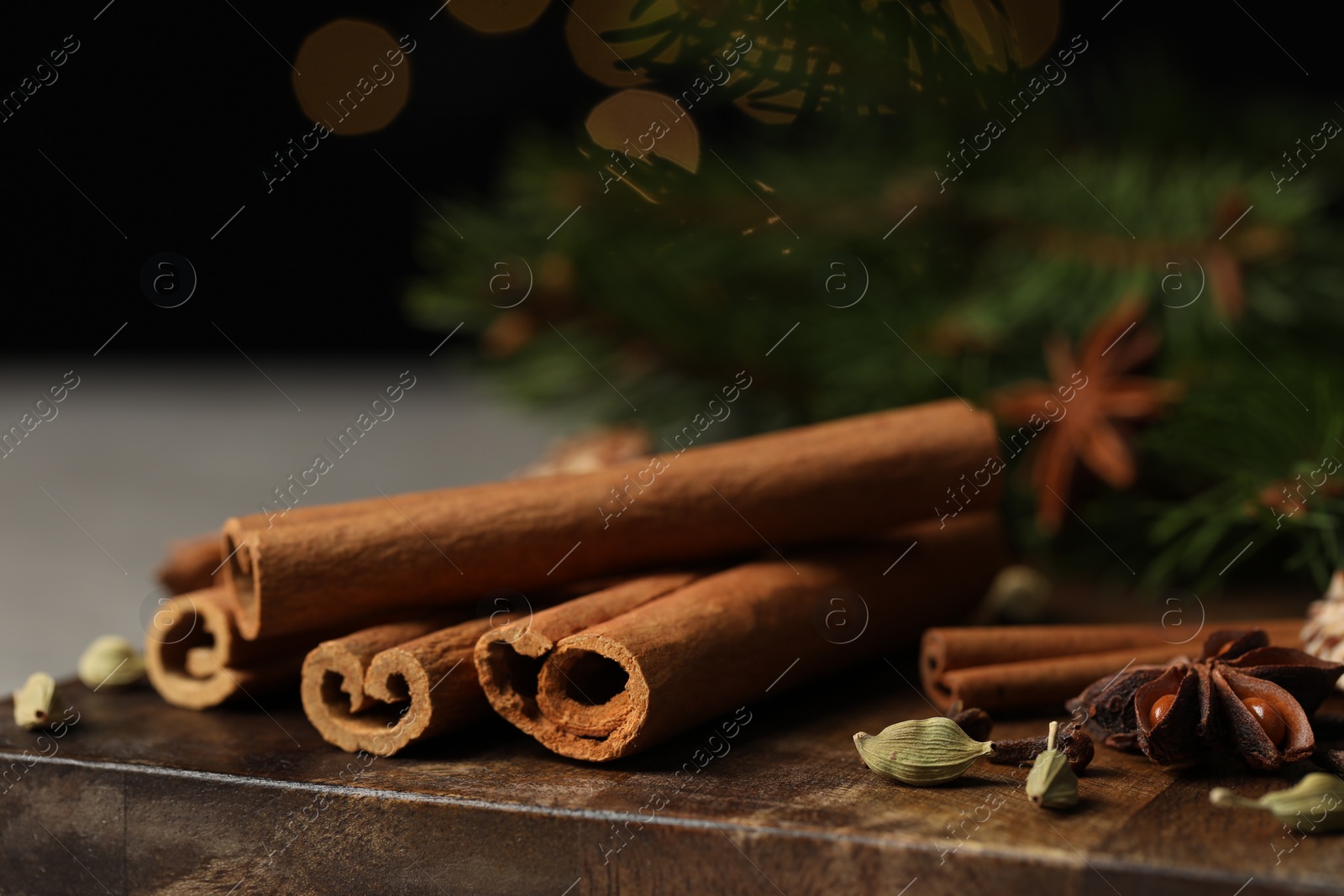 Photo of Board with different aromatic spices on table, closeup