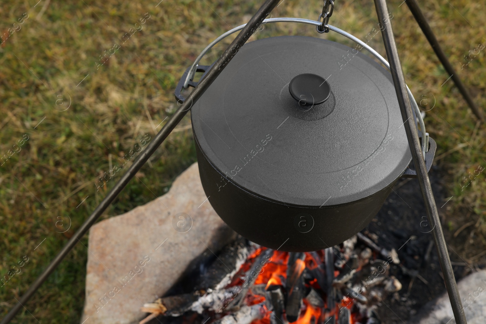 Photo of Cooking food on campfire outdoors. Camping season