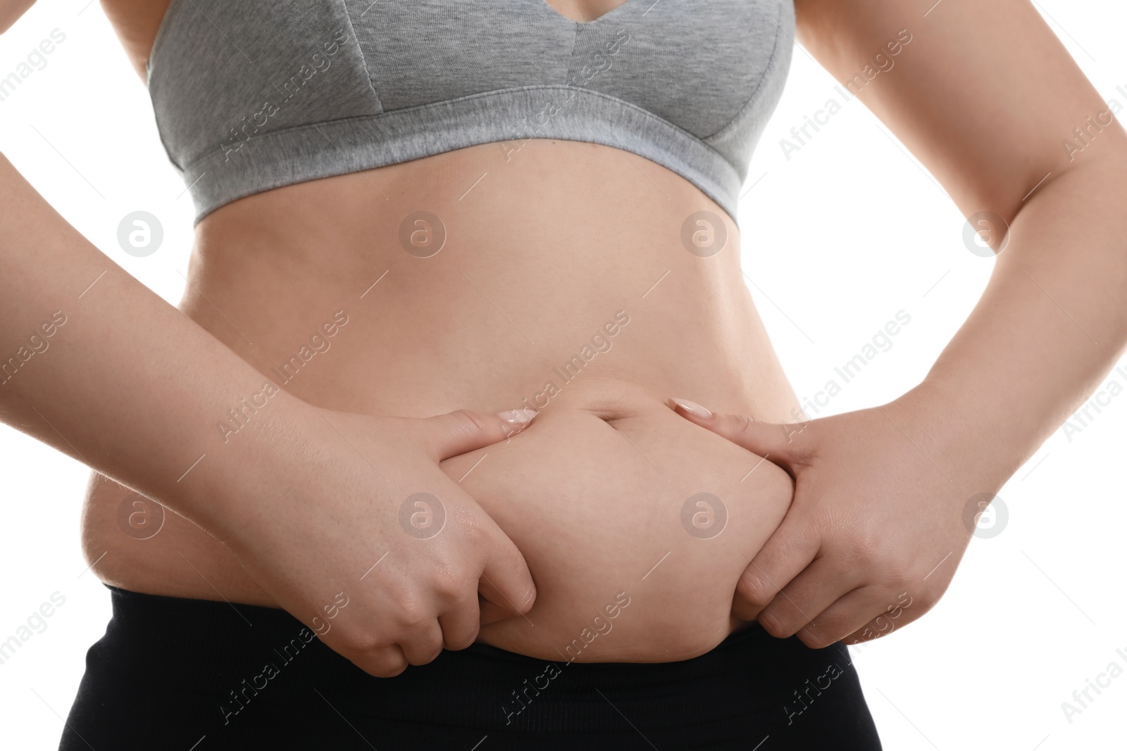 Photo of Woman touching belly fat on white background, closeup. Overweight problem