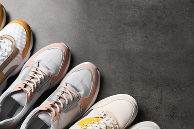 Flat lay composition with sneakers and space for text on grey background. Stylish shoes