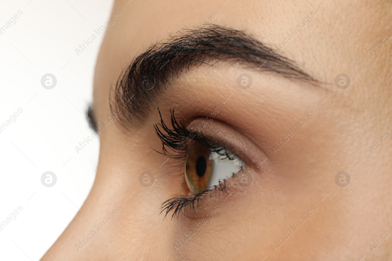 Photo of Beautiful young woman against white background, closeup view. Focus on eye