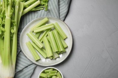 Fresh green celery on light grey table, flat lay. Space for text