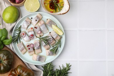 Photo of Tasty fish with spices, products and marinade on light tiled table, flat lay. Space for text