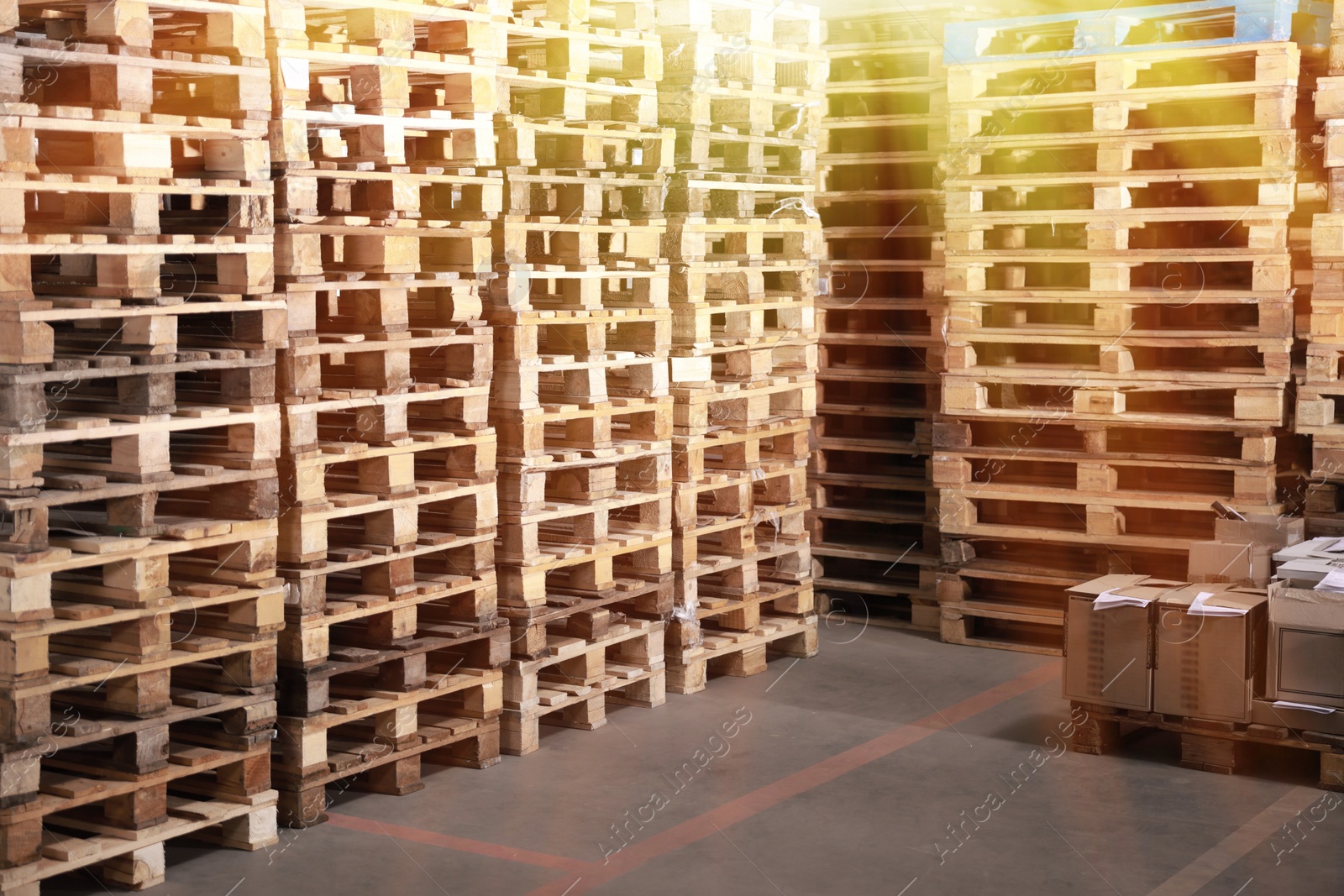 Image of Many empty wooden pallets stacked in warehouse