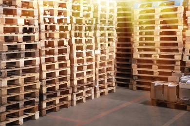 Image of Many empty wooden pallets stacked in warehouse