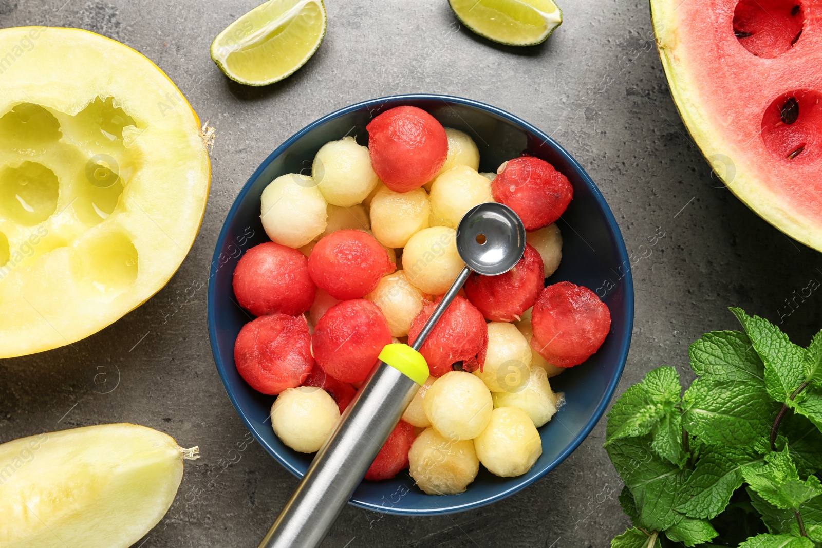 Photo of Flat lay composition with melon and watermelon balls on grey background