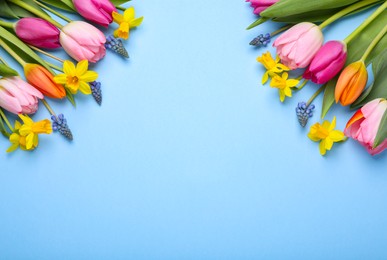 Photo of Beautiful flowers on light blue background, flat lay. Space for text