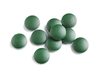 Photo of Spirulina tablets on white background, top view. Healthy lifestyle