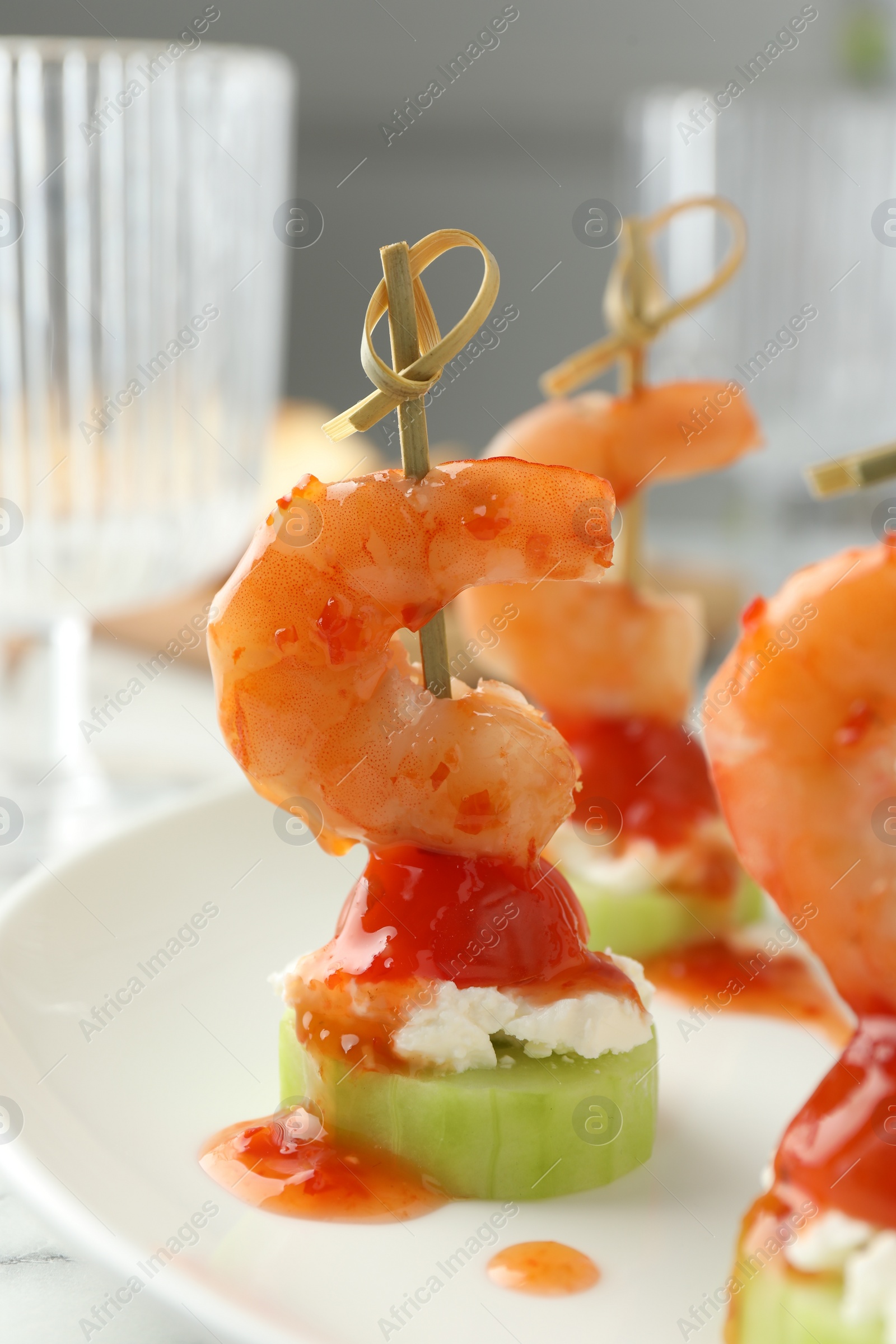 Photo of Tasty canapes with shrimps, vegetables and cream cheese on white table, closeup