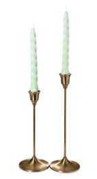 Photo of Vintage metal candlesticks with candles on white background