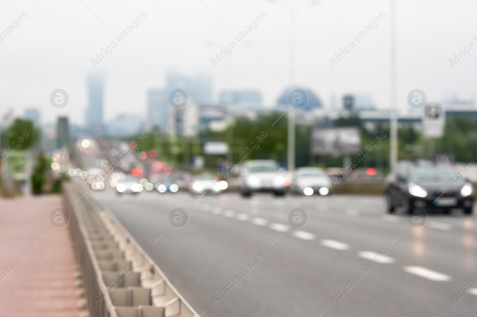 Photo of Blurred view of city road with cars