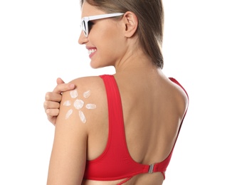 Woman with sun protection cream on body against white background