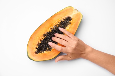 Photo of Young woman touching half of papaya on white background, top view. Sex concept