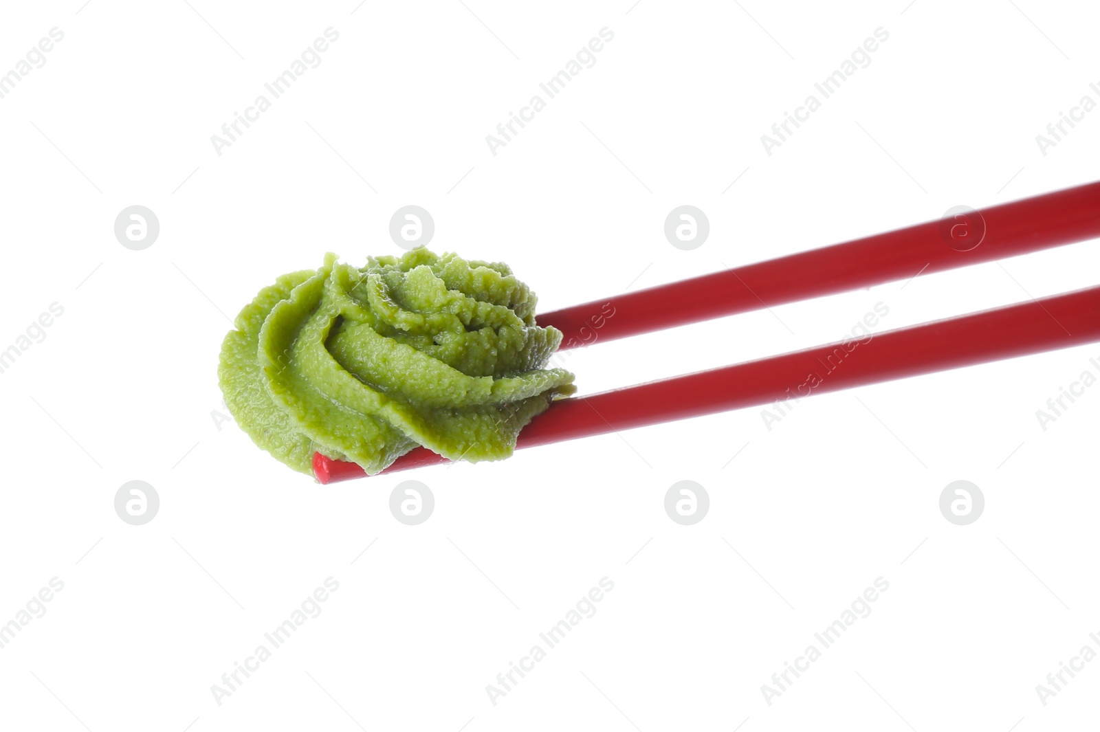 Photo of Chopsticks with swirl of wasabi paste isolated on white