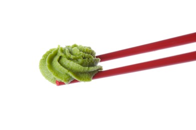 Photo of Chopsticks with swirl of wasabi paste isolated on white