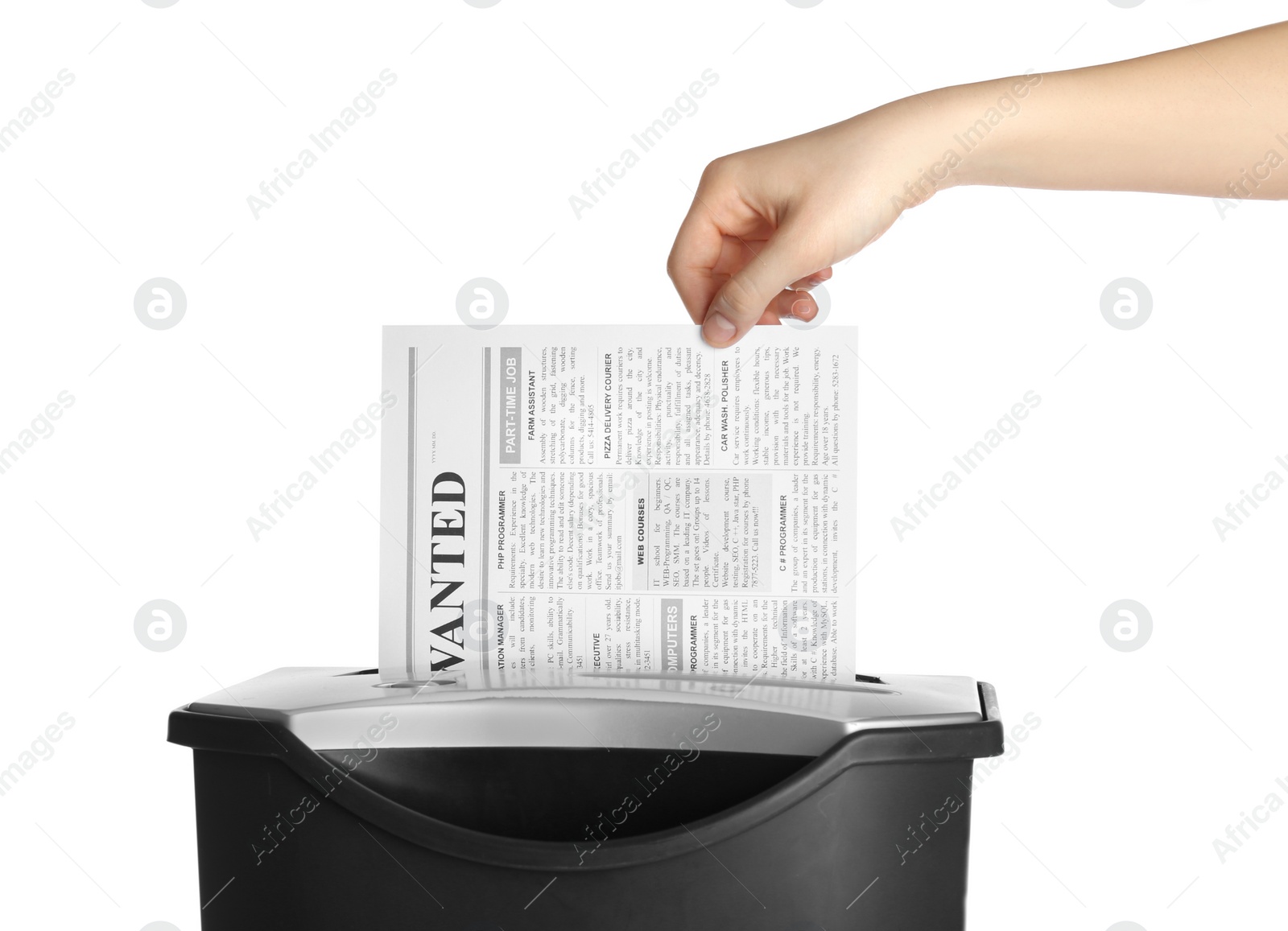 Photo of Woman destroying newspaper with paper shredder on white background, closeup