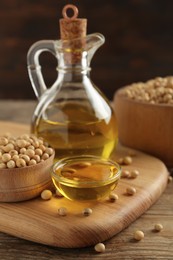 Photo of Composition with soybean oil on wooden table