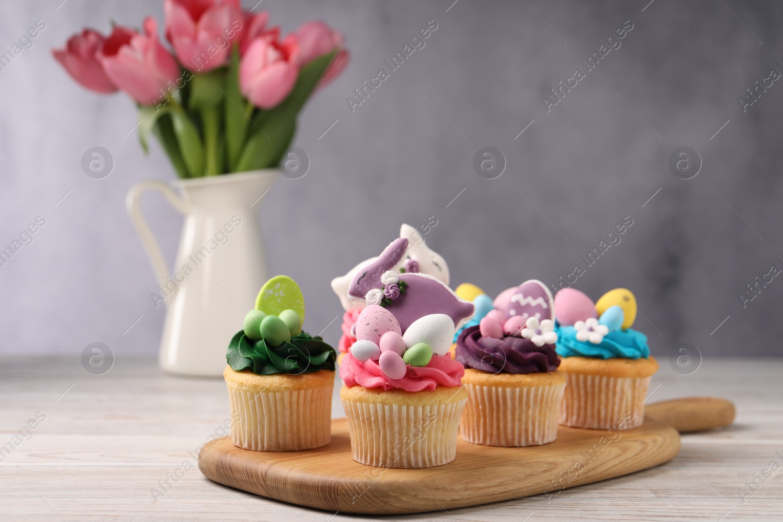 Photo of Tasty decorated Easter cupcakes on wooden table