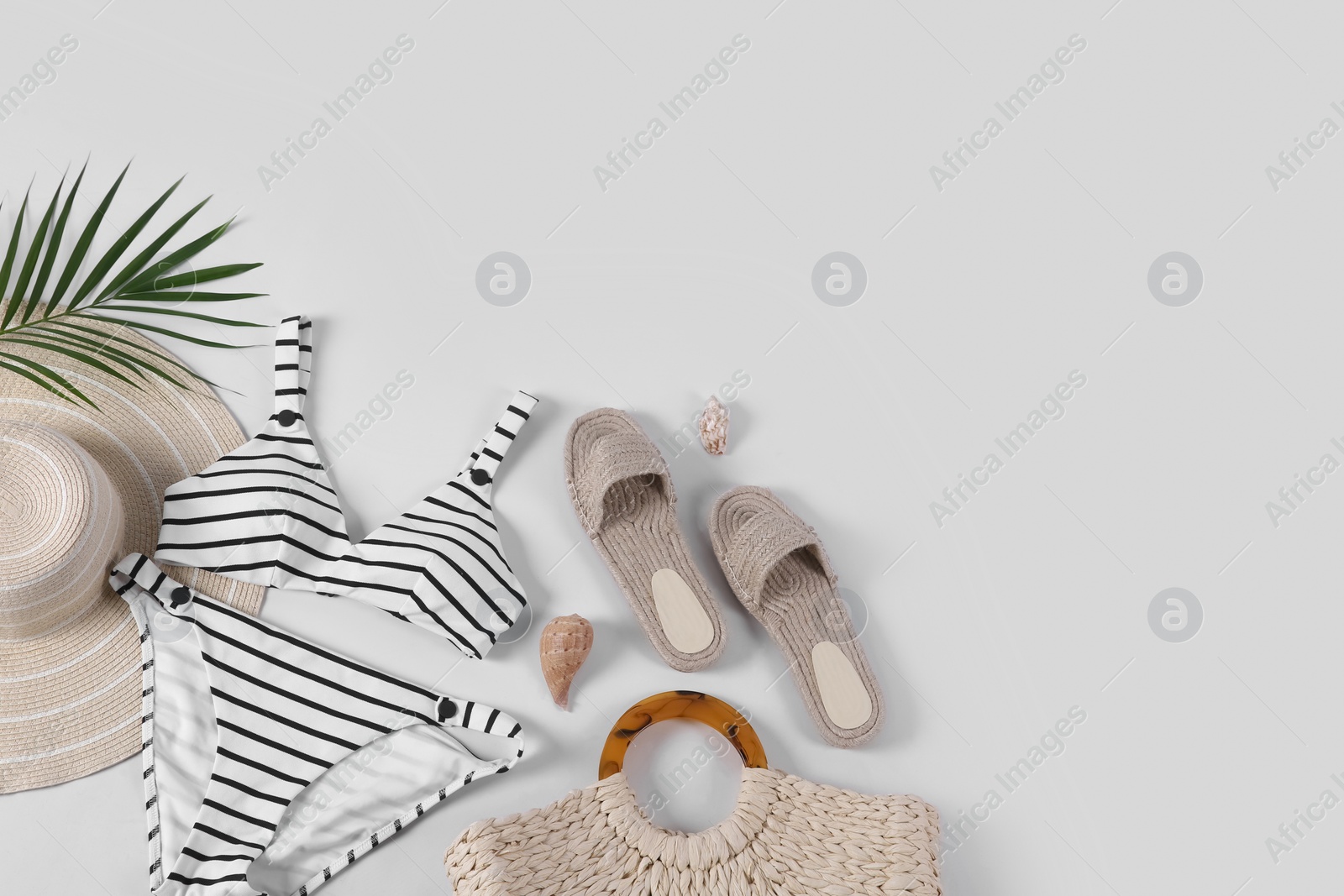 Photo of Flat lay composition with beach accessories on white background. Space for text