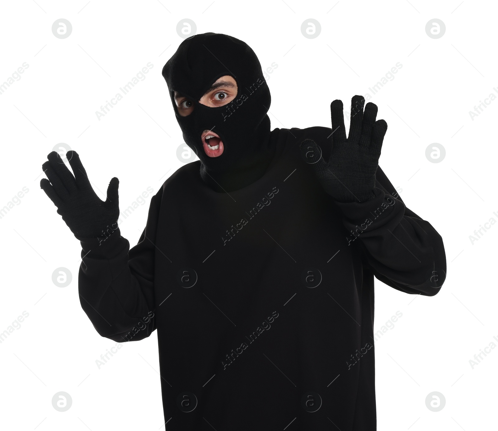 Photo of Emotional thief in balaclava raising hands on white background