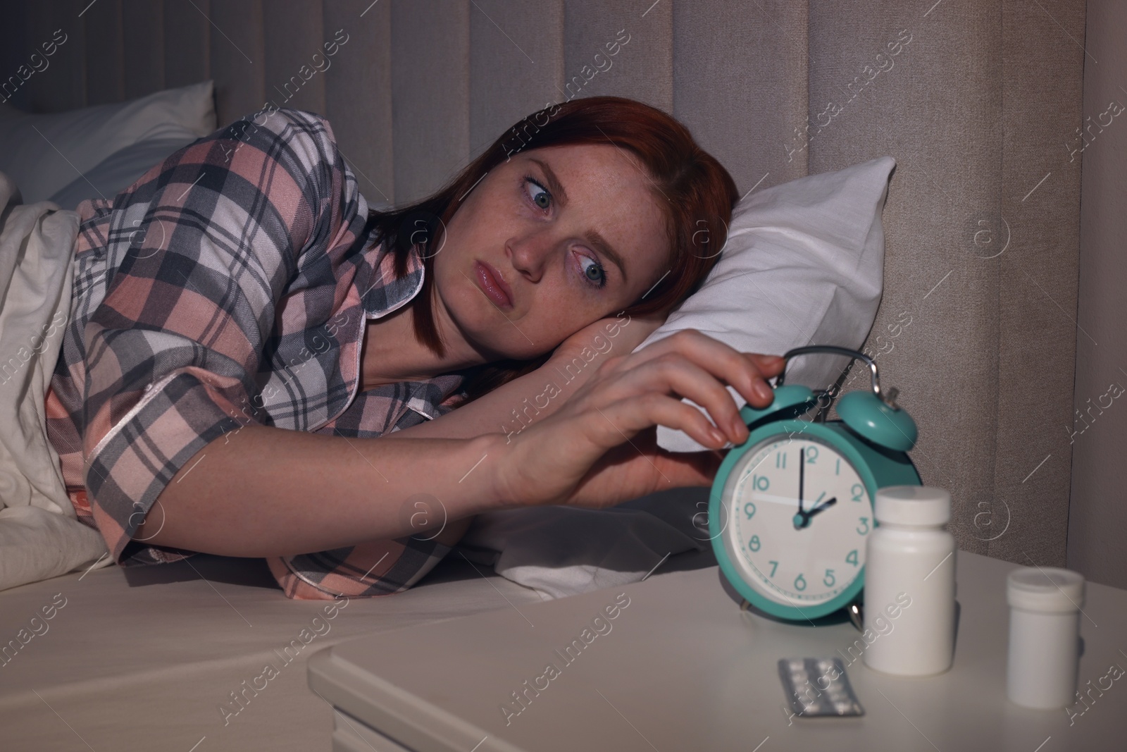 Photo of Woman suffering from insomnia in bed at home