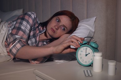 Woman suffering from insomnia in bed at home