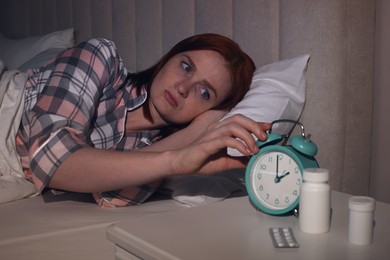 Photo of Woman suffering from insomnia in bed at home