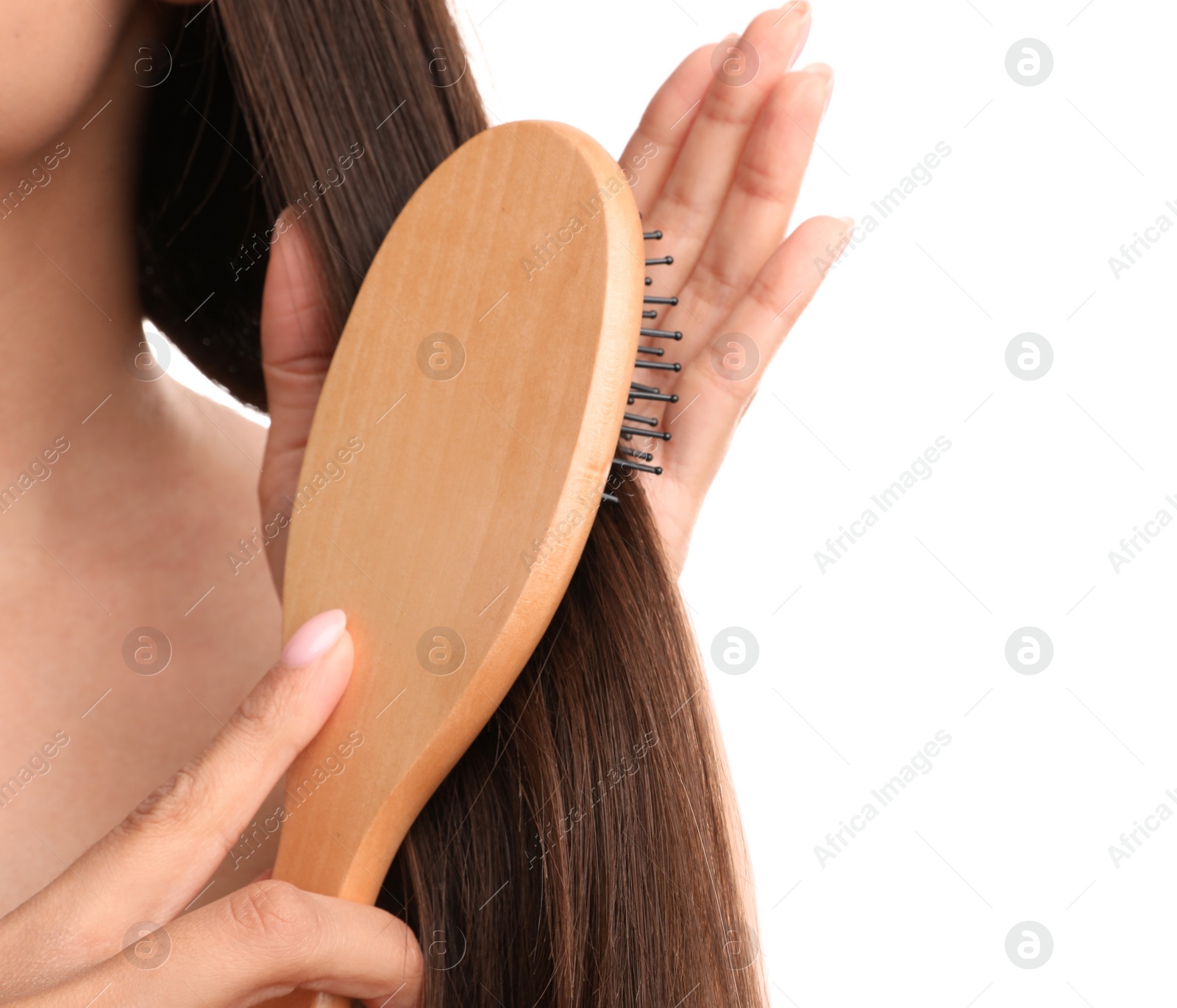 Photo of Woman with hair brush on white background, closeup